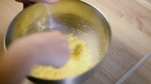 Mixing raw cookie dough with a fork inside a metal bowl Stock Footage 342704060