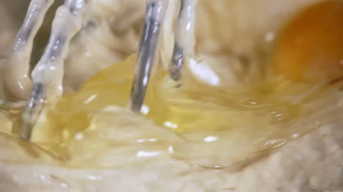 Mixing raw eggs into flour during the baking process Stock Footage 162484151