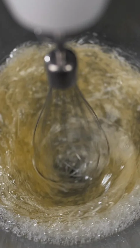 Mixing raw eggs to make dough using a mixer. Stock Footage 281666713