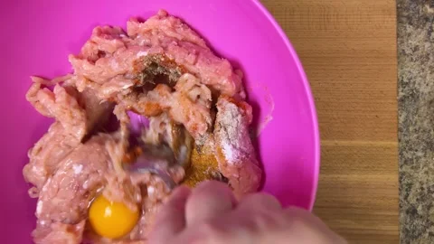 Mixing raw minced chicken with raw chicken egg, salt and spices.  Stock Footage 301331090