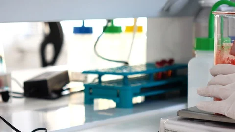 Mixing red food coloring supplements inside a lab Stock Footage 101229890