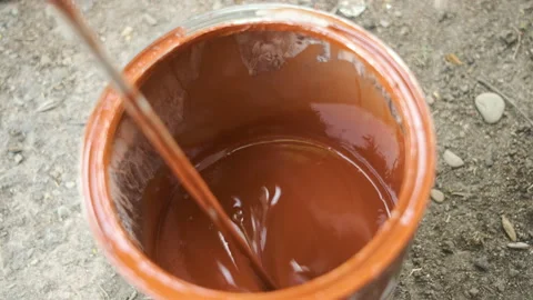 Mixing red paint. Dilution to liquid Stock Footage 130983225