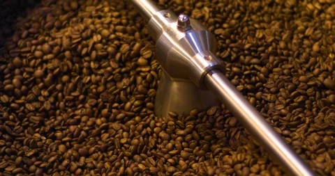 Mixing roasted coffee beans in roaster machine. Flat plane Stock Footage 98403147