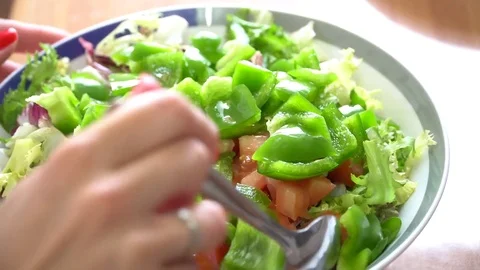 Mixing salad in a bowl with a spoon Stock Footage 79688151