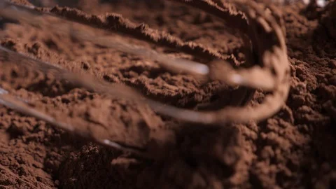 Mixing of the solid rolling cocoa powder, highlighted, slow motion( macro close Stock Footage 86490883