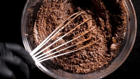 Mixing of the solid rolling cocoa powder, highlighted, slow motion( macro close Stock Footage 86492011