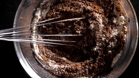 Mixing of the solid rolling cocoa powder, highlighted, slow motion( macro close Stock Footage 86492049