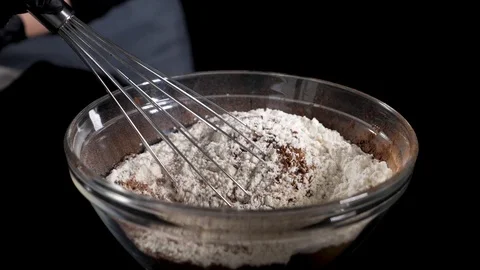 Mixing of the solid rolling cocoa powder, highlighted, slow motion( macro close Stock Footage 86492117