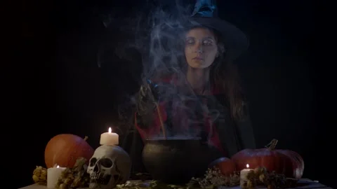 Mixing something in cauldron Stock Footage 141293260