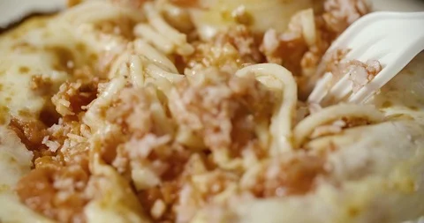 Mixing spaghetti with a fork and a disposable plastic knife Stock Footage 92167238