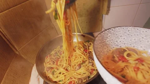 Mixing Spaghetti, Tomato Sauce and Beef in a Frying Pan Stock Footage 344670320