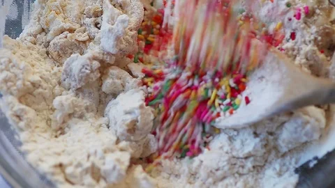 Mixing sprinkles into cookie batter Stock Footage 88711147