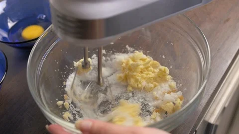 Mixing sugar and butter in a glass bowl. Stock Footage