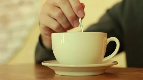 Mixing sugar in a cup of tea Vídeo Stock 73506841