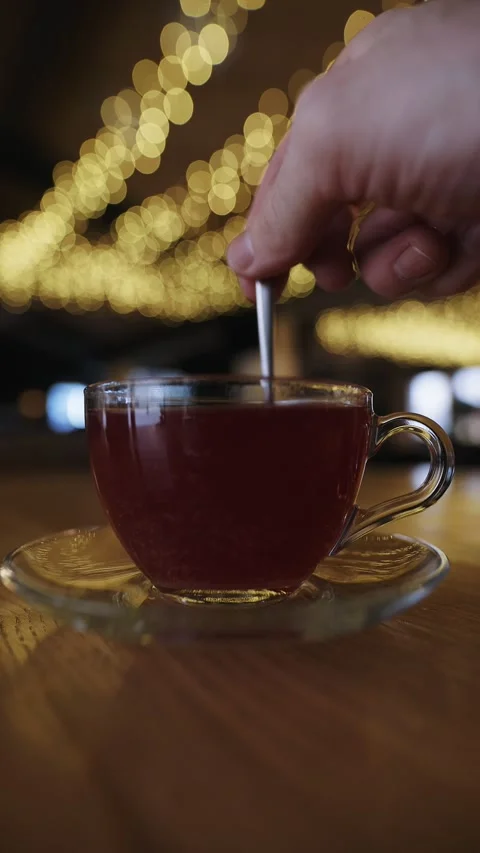 Mixing sugar in a raspberry tea cup, slow motion vertical video Stock Footage 330310699