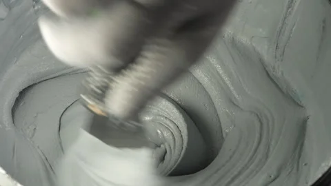 Mixing a textured gray paste for artistic and construction use Stock Footage 305738535