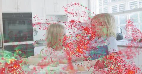 Mixing two children wearing patterned shirt and apron preparing dough at kitchen Stock Photos