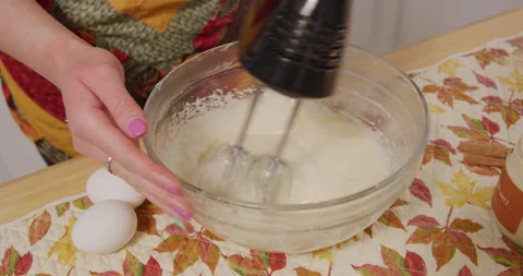 Mixing vanilla extract and mix in mixing bowl with hand mixer Stock Footage 249359735