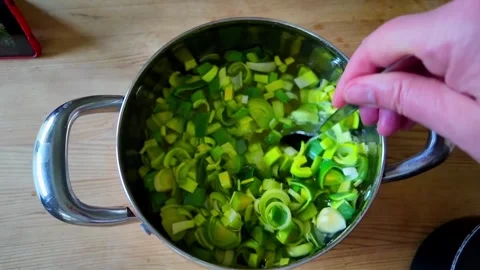 Mixing vegetables in a pan Stock Footage 317701187