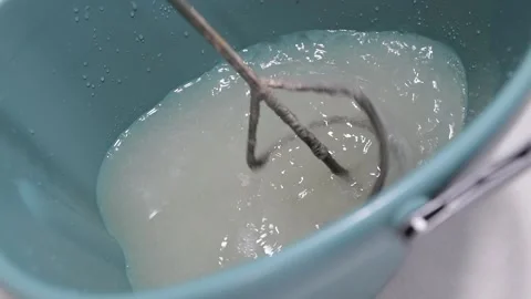 Mixing wallpaper glue. The process of preparing wallpaper glue. Preparation of 動画素材 333122768