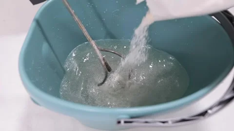 Mixing wallpaper glue. The process of preparing wallpaper glue. Preparation of Video stock 335619755