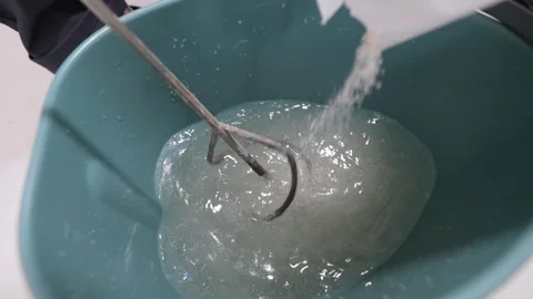 Mixing wallpaper glue. The process of preparing wallpaper glue. Preparation of Stock Footage 335619779