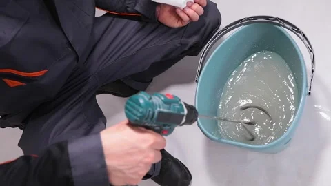 Mixing wallpaper glue. The process of preparing wallpaper glue. Preparation of Stock Footage 335619826