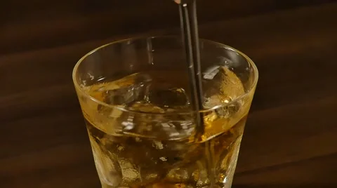 Mixing whiskey with ice Stock Footage 57129974