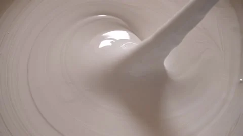 Mixing white paint in a bucket Stock Footage 239226654