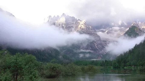 Mixture of Clouds with a Mist over a Mountain Lake. Fast Motion Stock Footage