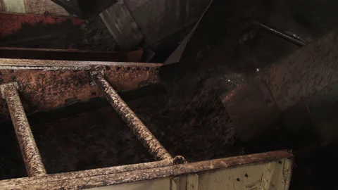 Mixture of coal and water is poured from pipe onto vibrating screen. Water Stock Footage 205220330