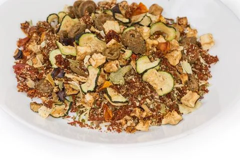 Mixture of different dried vegetables and spices on white dish Stock Photos