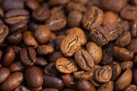 Mixture of different kinds of roasted coffee beans background. Stock Photos