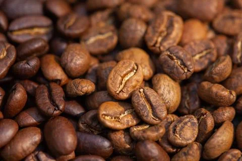 Mixture of different kinds of roasted coffee beans background. Stock Photos