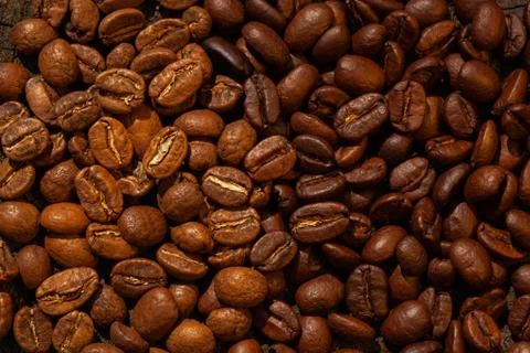 Mixture of different kinds of roasted coffee beans background. Stock Photos