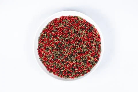 A mixture of different peppercorns on a white background, top view Stock Photos