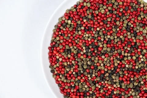 A mixture of different peppercorns on a white background, top view, copy sp.. Stock Photos