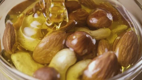Mixture of nuts in honey Stock Footage 85388777