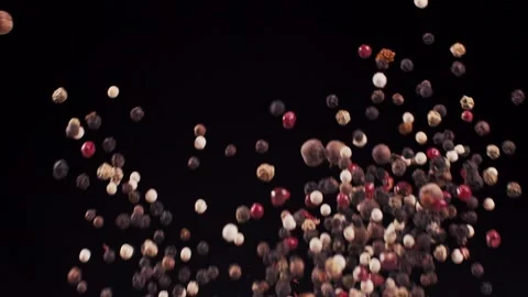 A mixture of peppers flies up on a black background 動画素材 159122630