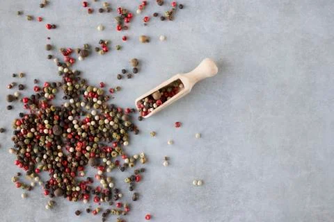 A mixture of peppers on a gray background. Stock Photos