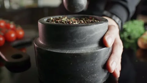 A mixture of peppers ground in a stone mortar, cooking in slow motion Video stock 105418086