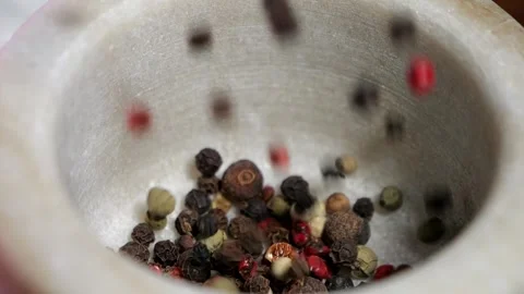 A mixture of peppers in peas. Grinding spices in a stone mortar. Stock Footage 266285228