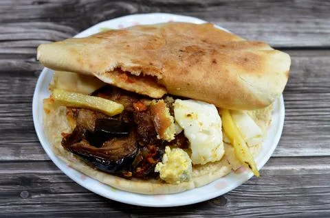 Mixture of potatoes fried fingers, mashed fava beans, fried aubergine, Egyp.. Stock Photos