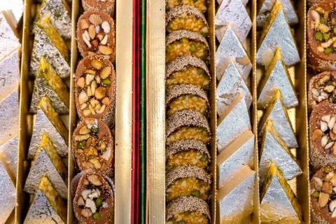 A mixture of various Indian sweets packed in a box. Peda, laddu, mithai, diwa Stock Photos