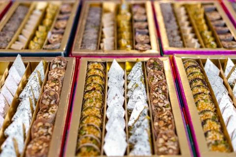 A mixture of various Indian sweets packed in a box. Peda, laddu, mithai, diwa Stock Photos