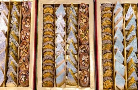 A mixture of various Indian sweets packed in a box. Peda, laddu, mithai, diwa Stock Photos