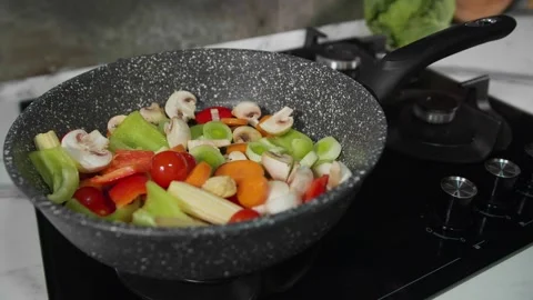 A mixture of vegetables in a frying pan 1 Video stock 268576194