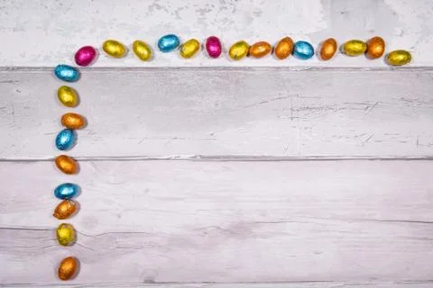 Mixtures of easter eggs of all colors and sizes on a background of old wooden 库存照片