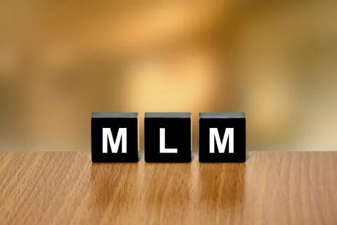 MLM or Multi Level Marketing on black block Stock Photos