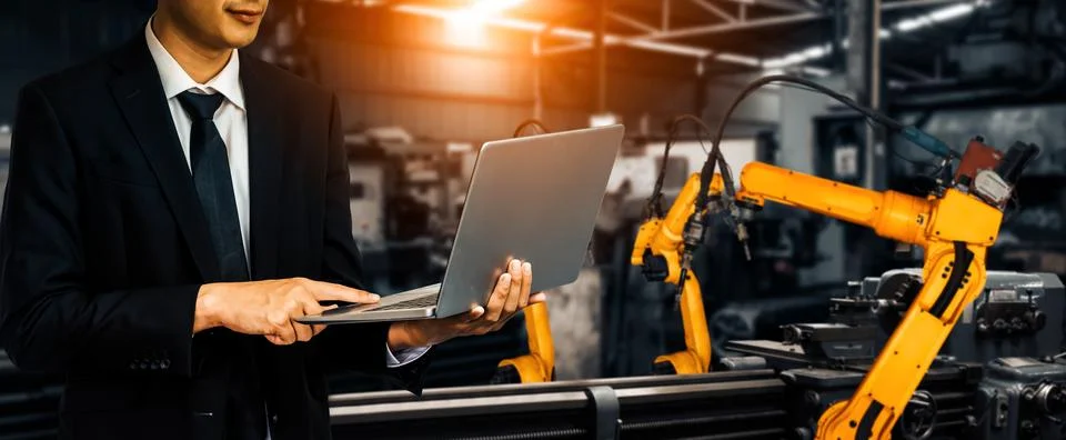 MLP Engineer use advanced robotic software to control industry robot arm in 스톡 사진